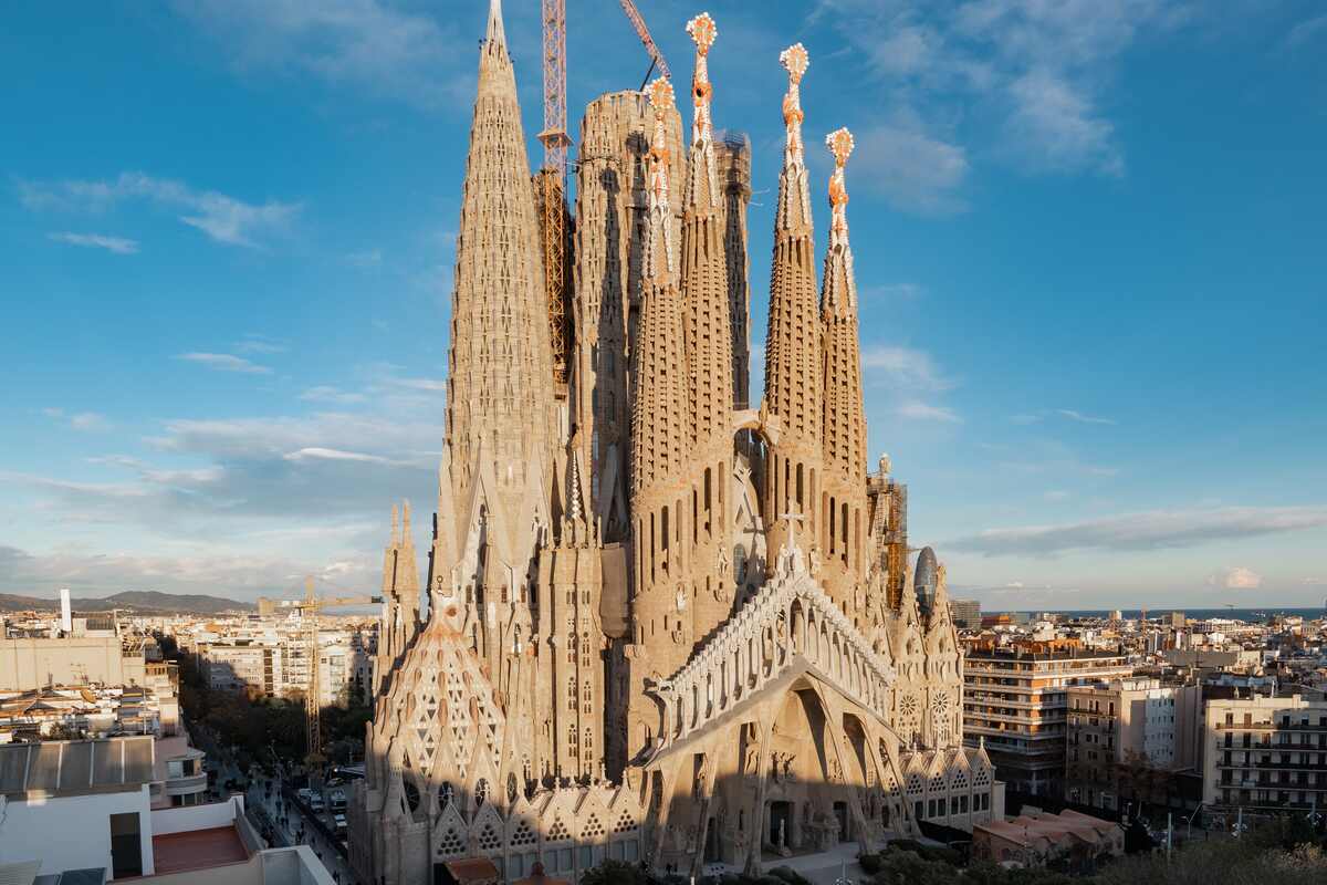 Ornate basilica with towers under clear blue sky.
