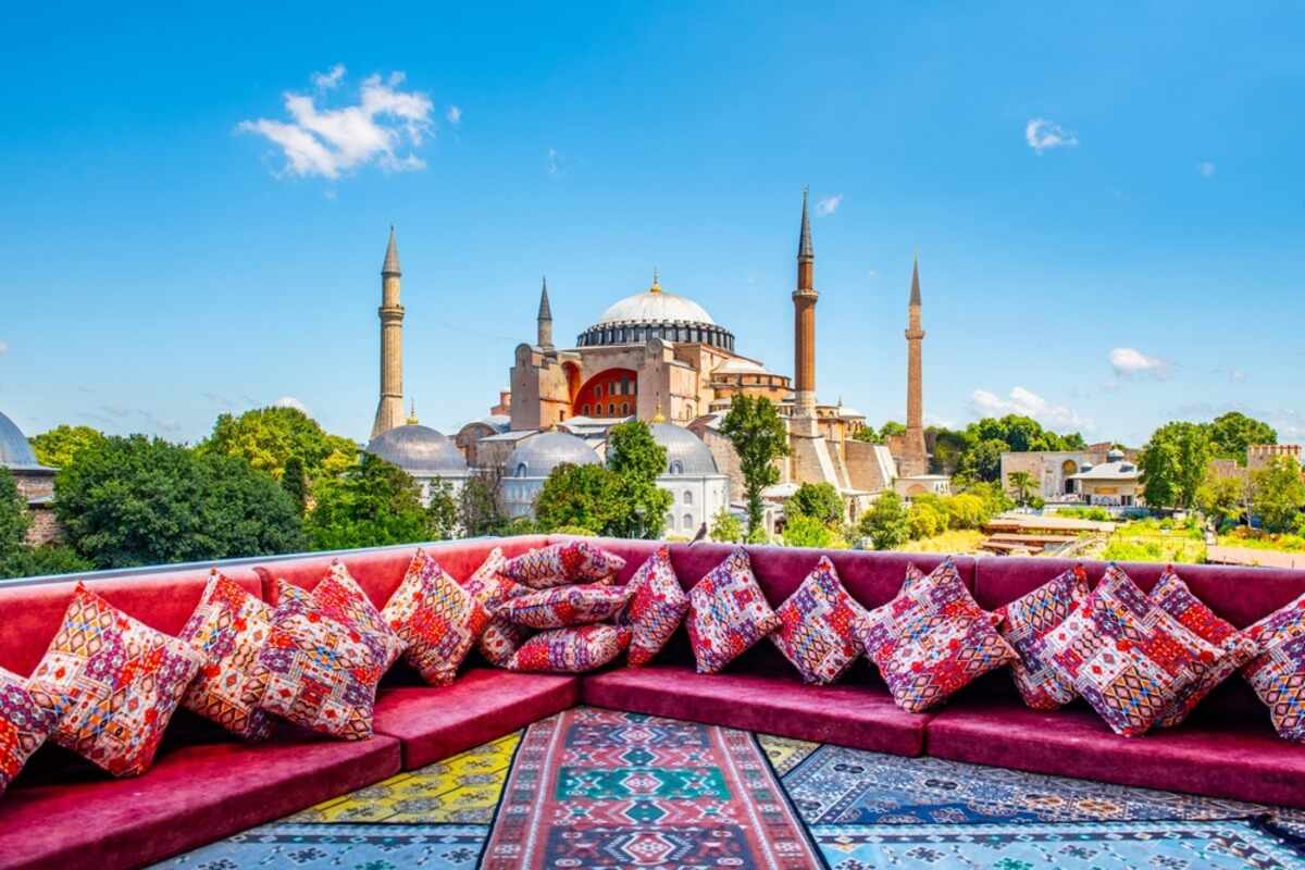 Red seating area with Hagia Sophia view and colorful pillows.