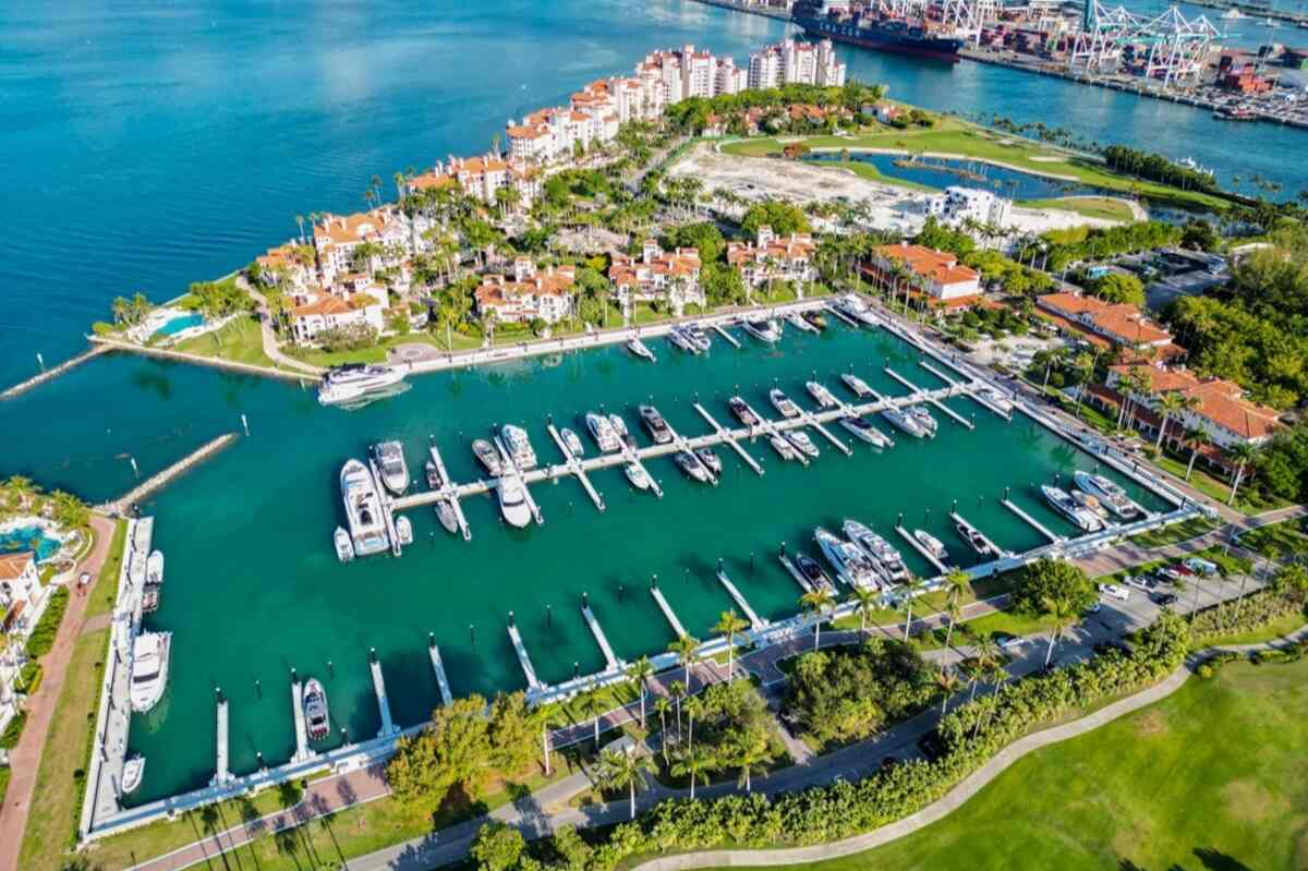 Marina with yachts, luxury homes, and a golf course.
