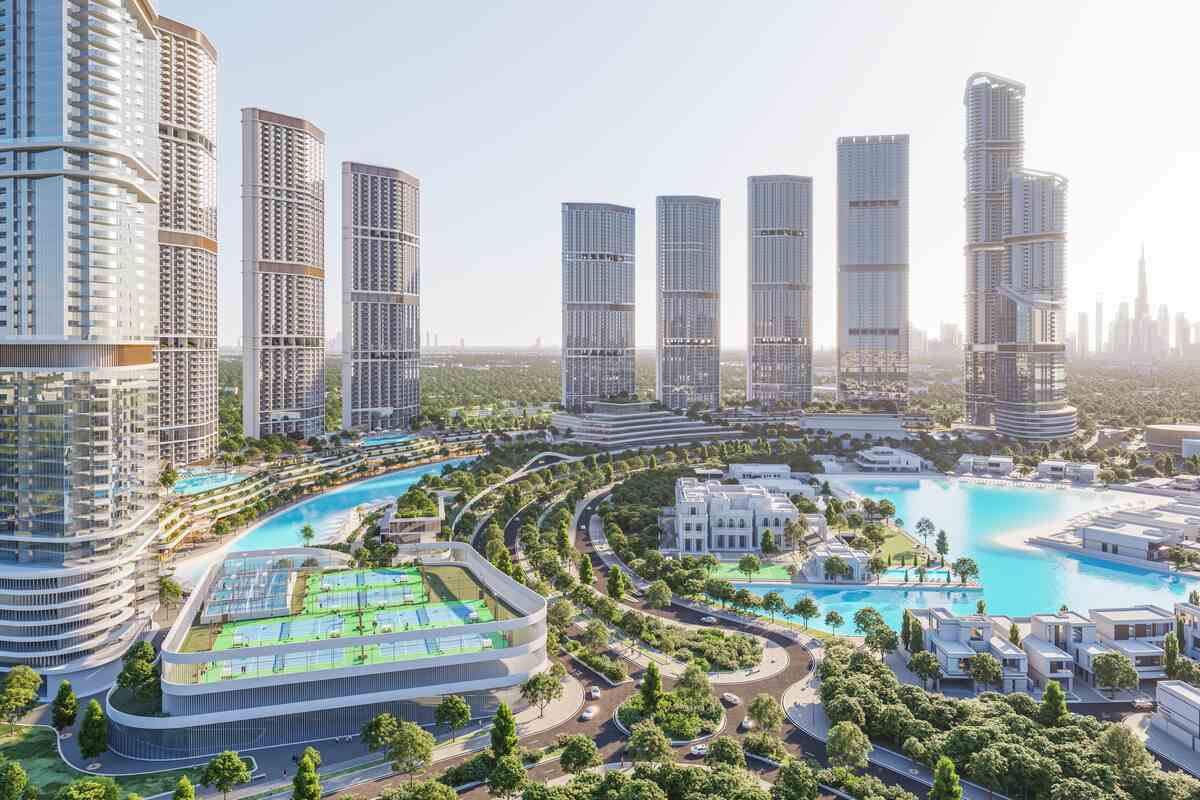 Residential towers around lagoon with tennis courts and greenery.