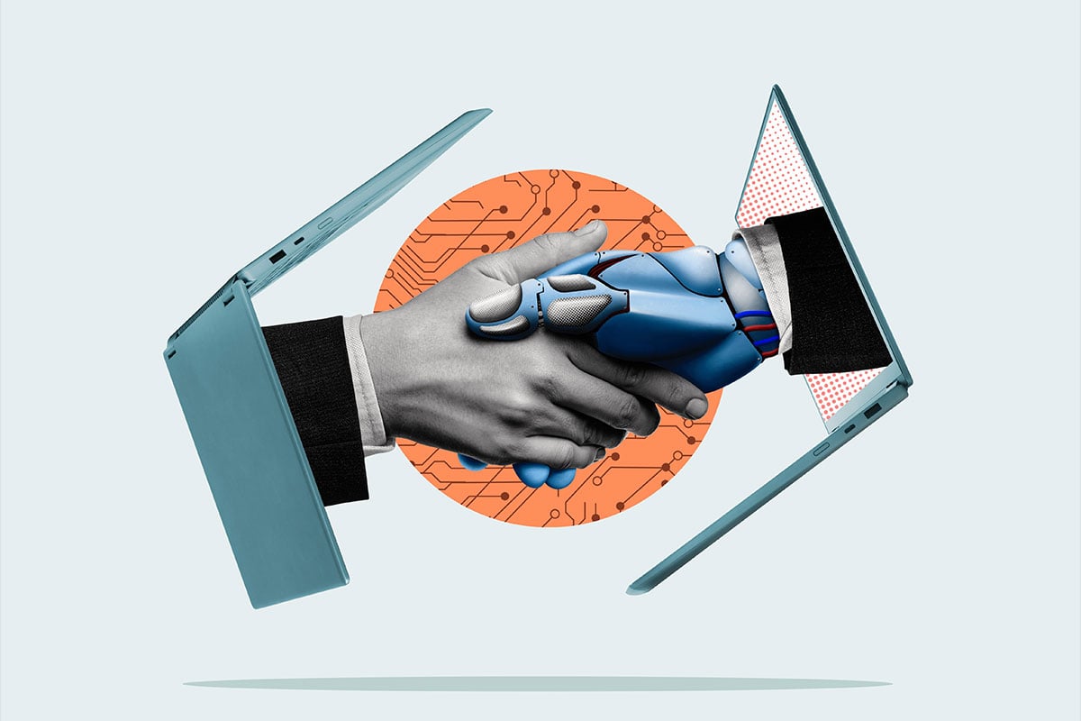 Human and robotic hands shake, symbolizing collaboration.