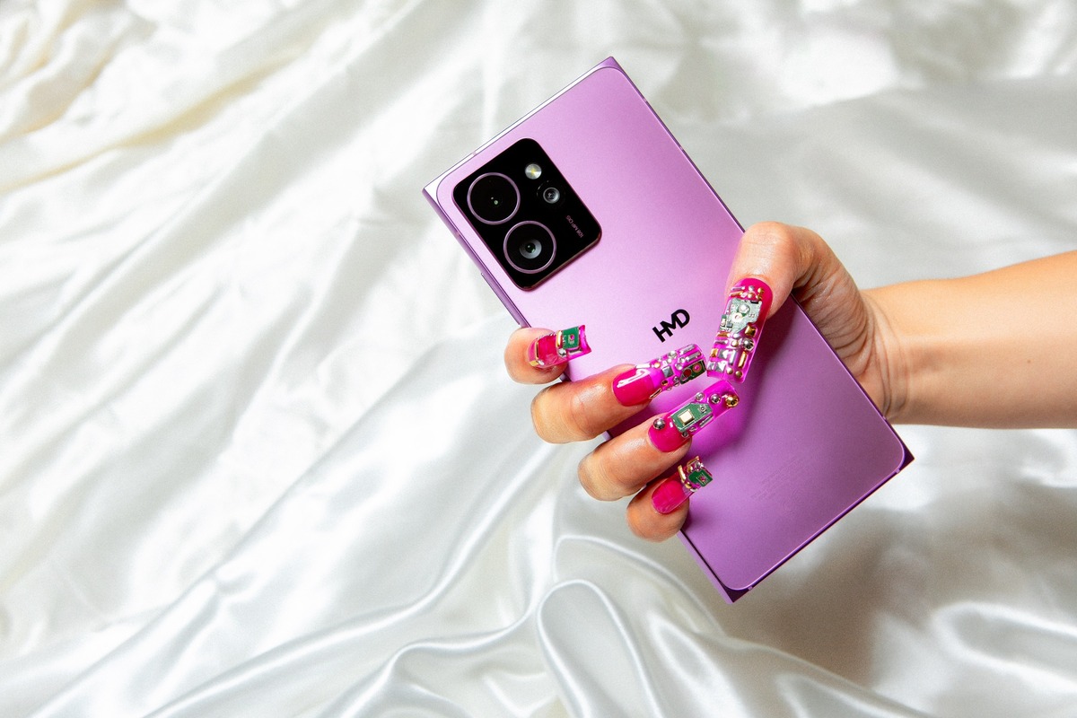 Purple smartphone with circuit board design in hand.
