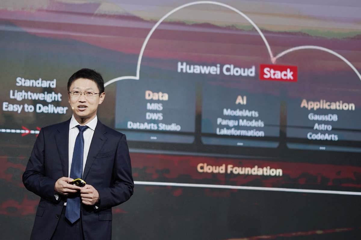 Presenter explains Huawei Cloud Stack system on stage.