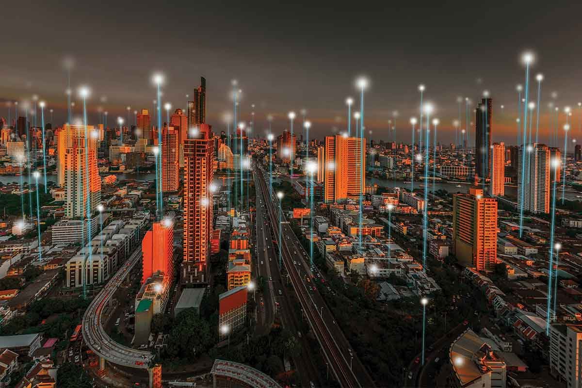 Cityscape at dusk with digital network connections.