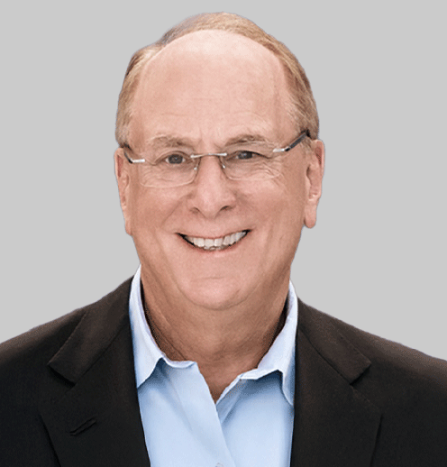 Smiling man in suit and glasses.