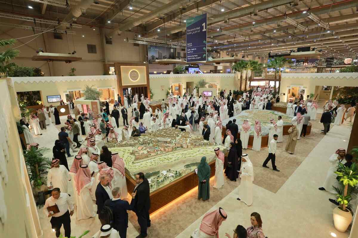 People viewing a city model in a Saudi building.